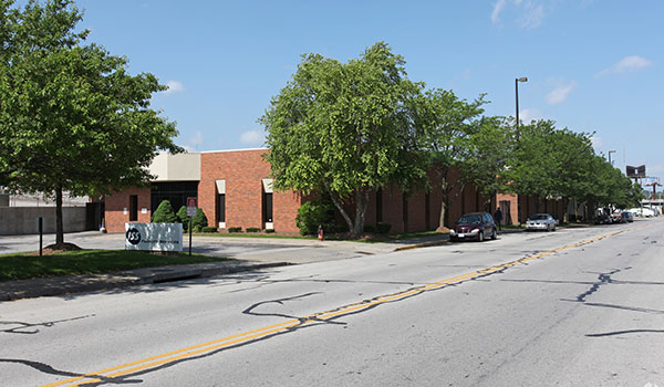 building and road with trees